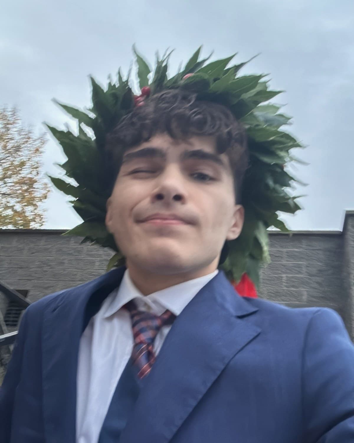 Michele Rossetti, founder of Otium, wearing the laurel wreath of his graduation